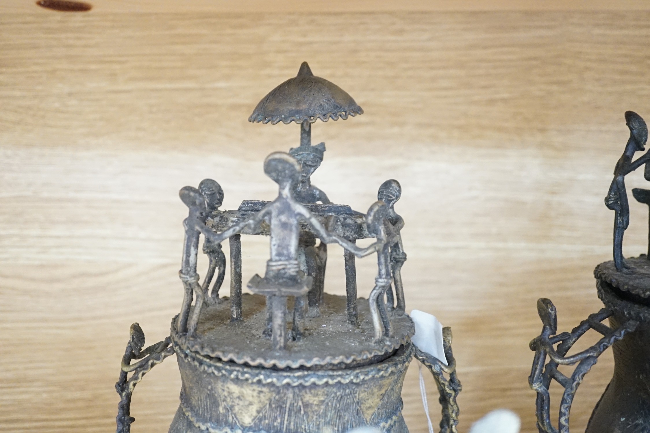 A collection of four Ashanti bronze figural vessels, and nine single figures, tallest 29cms high
